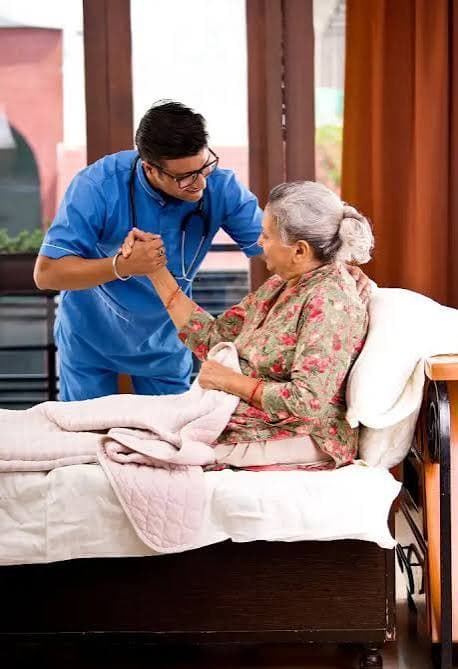 Caregiver supporting an elderly patient at home
